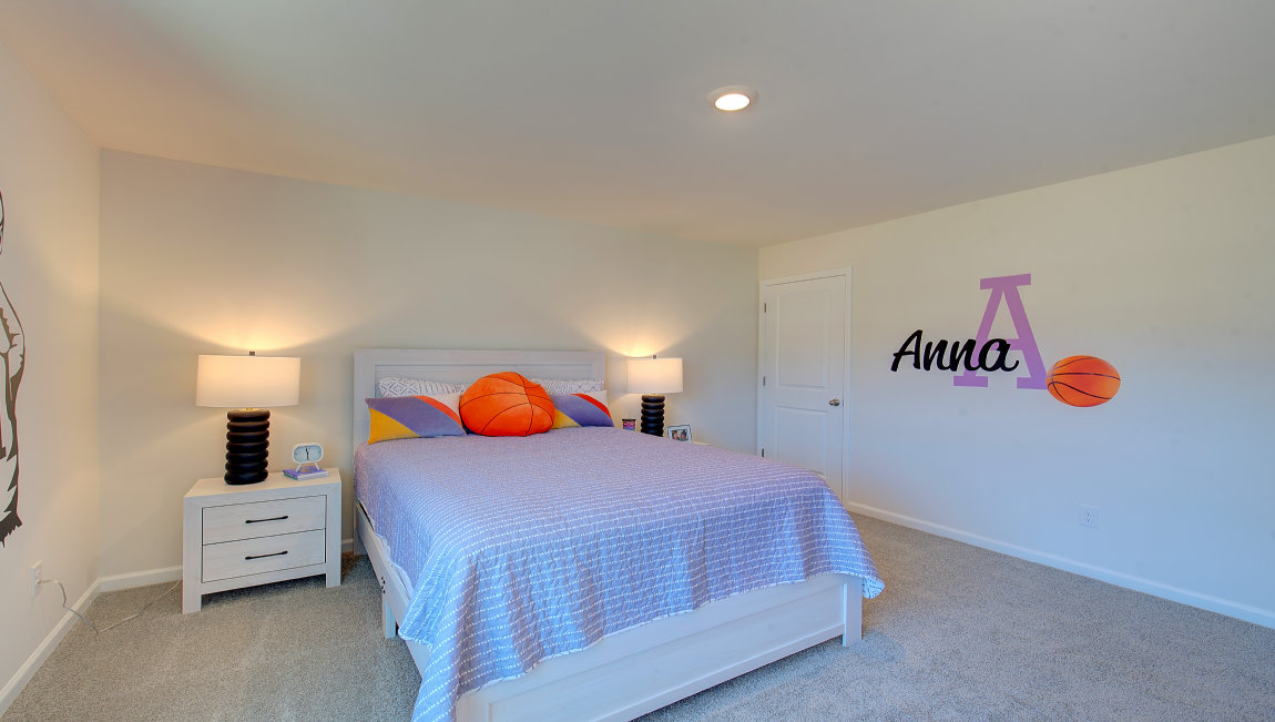 Carpeted bedroom with large windows