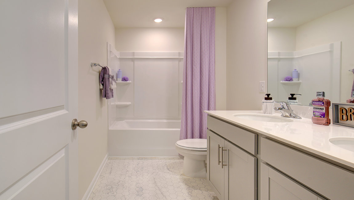 Bathroom with dual vanity and bathtub