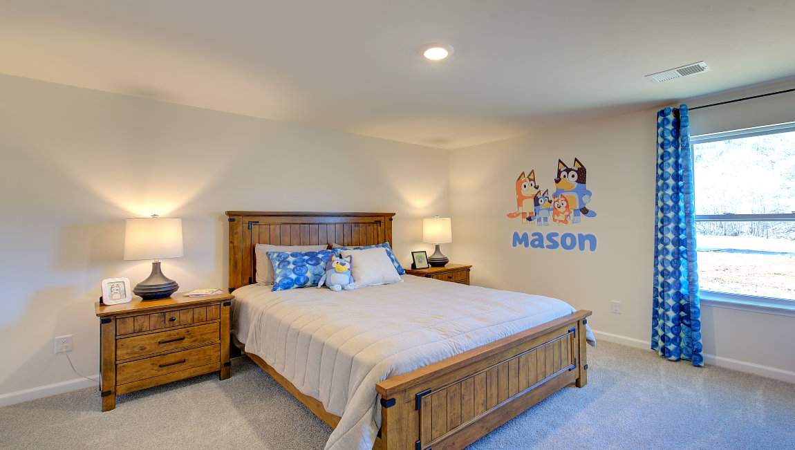 Carpeted bedroom with large windows