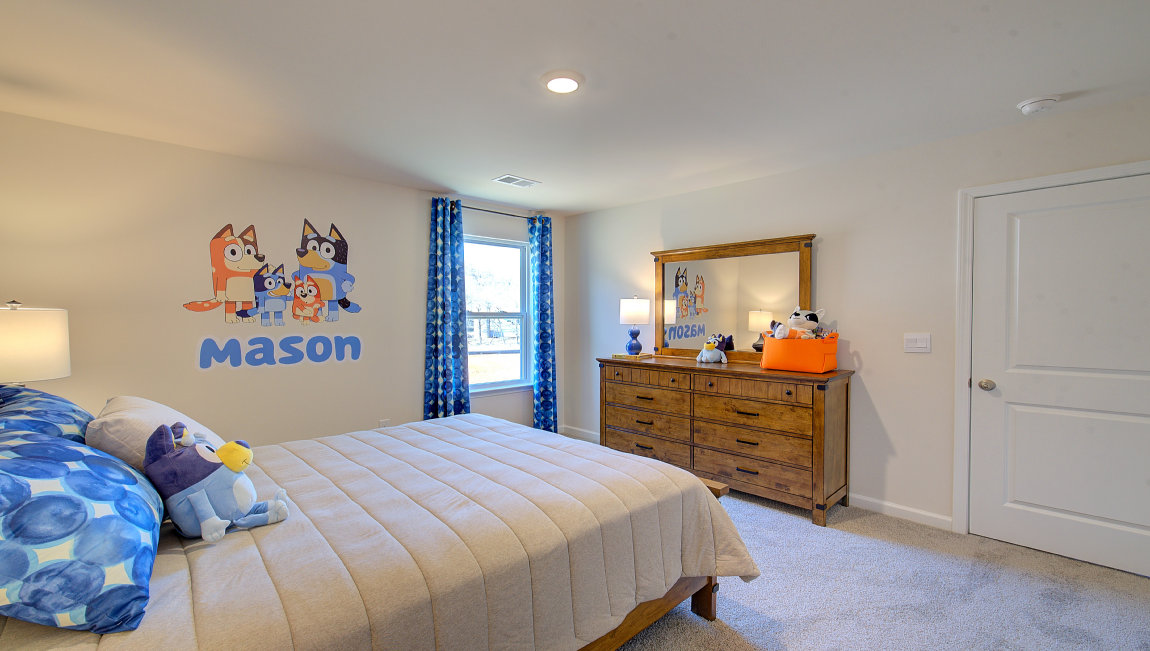 Carpeted bedroom with large windows