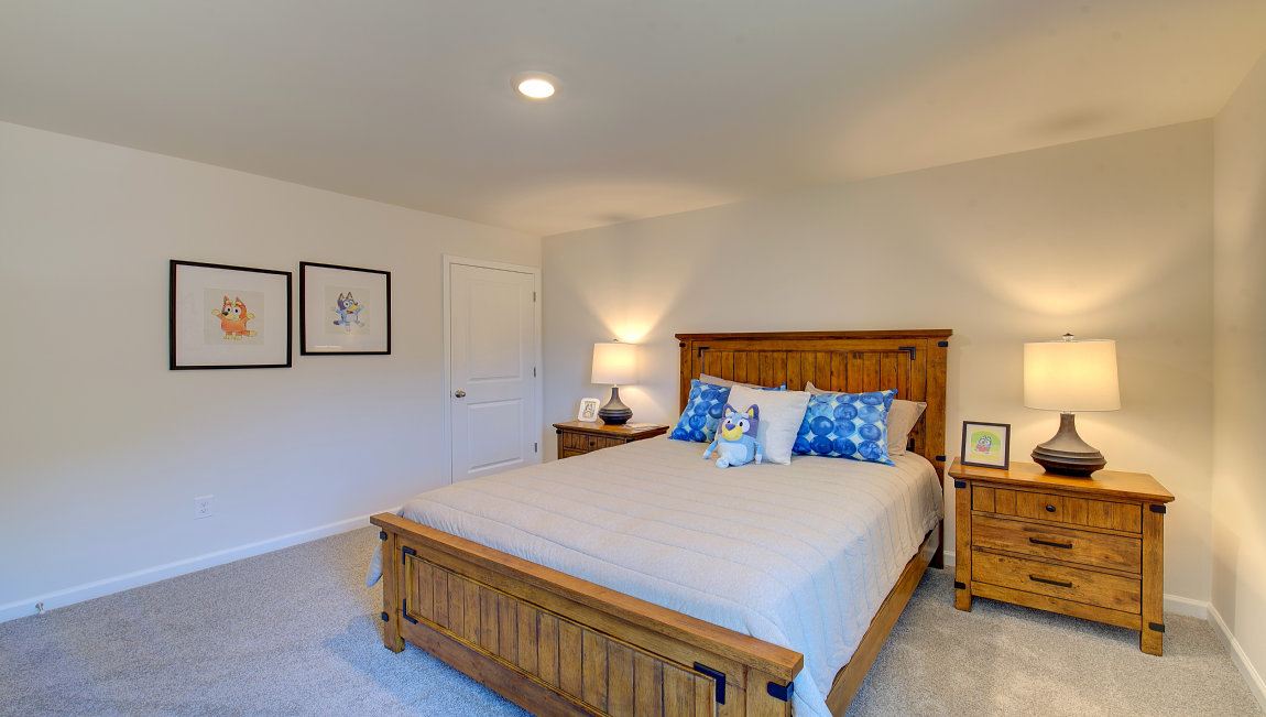 Carpeted bedroom with large windows