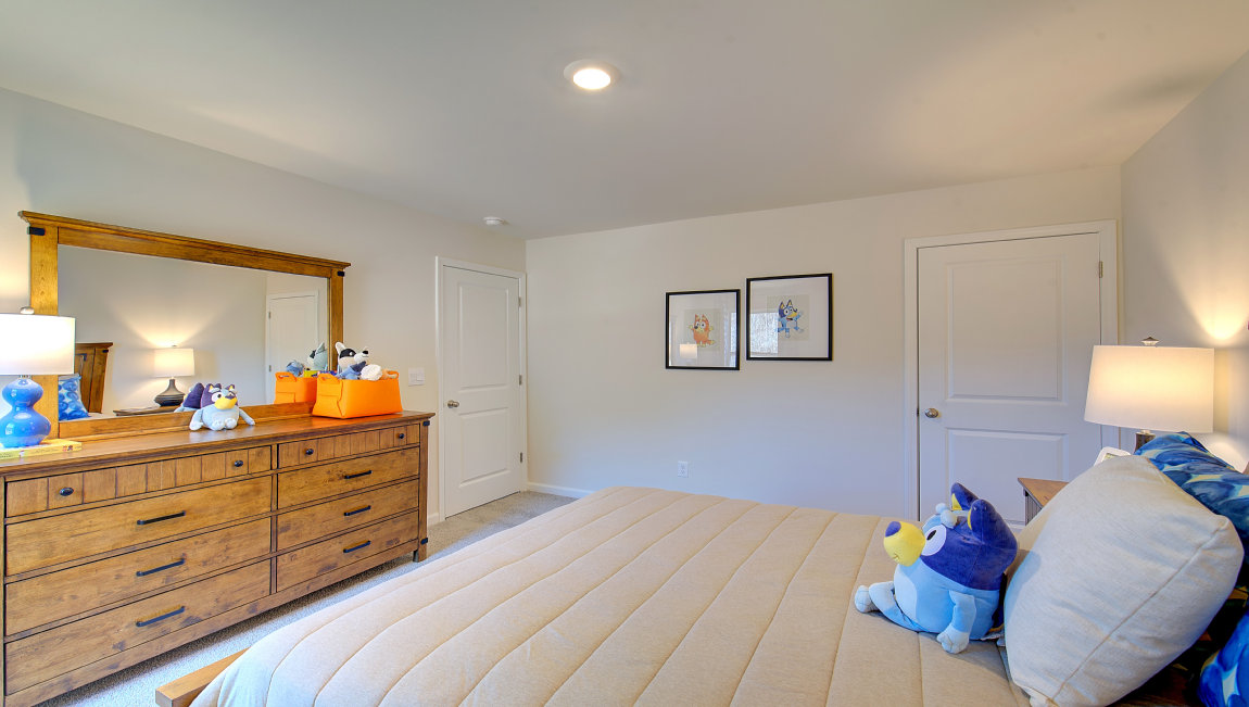 Carpeted bedroom with large windows