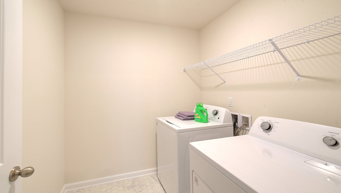 Laundry room with washer, dryer and shelving