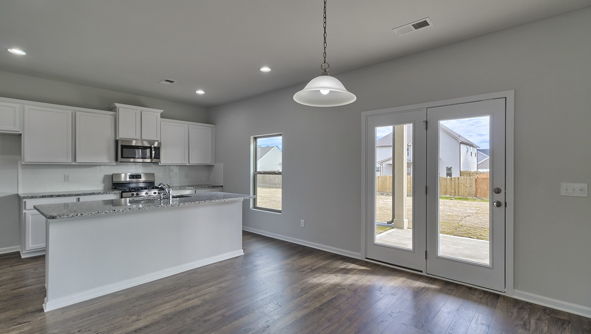 Open kitchen area with large windows and sliding glass doors