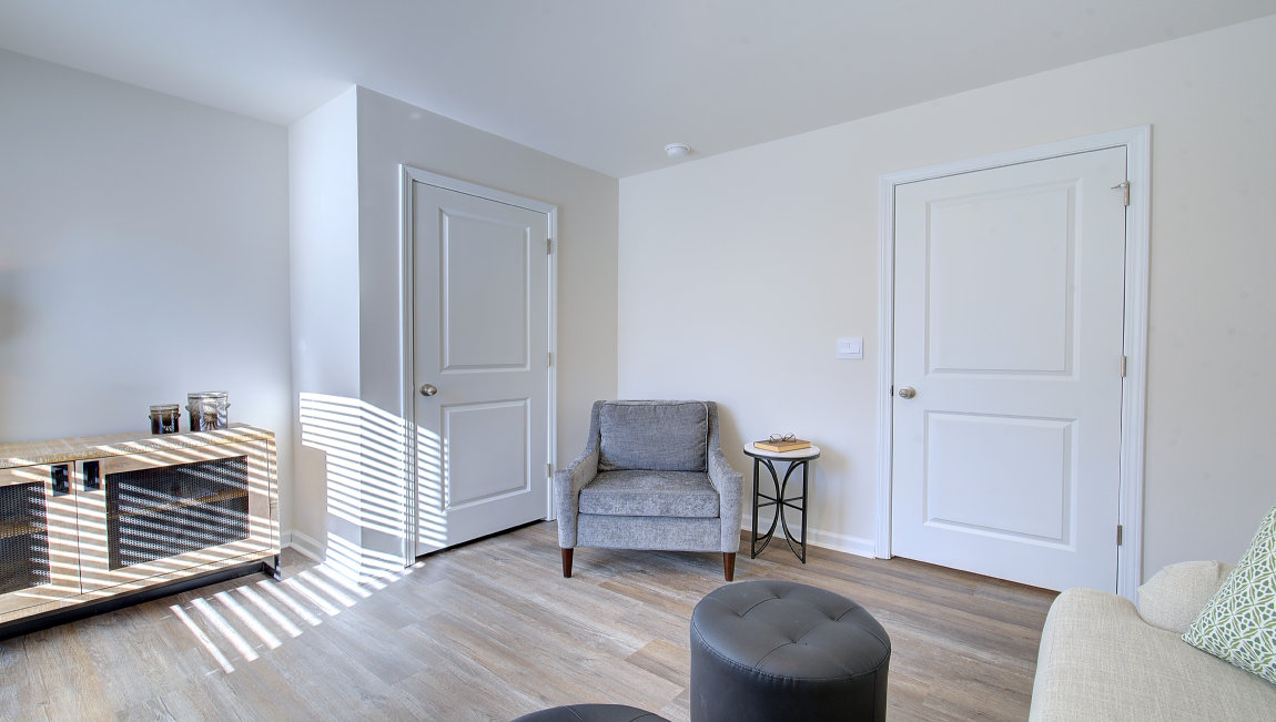 Downstairs bedroom with large window and closet