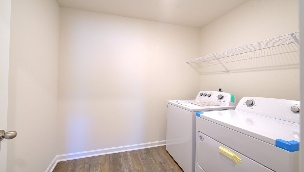 Laundry room with washer, dryer and shelving