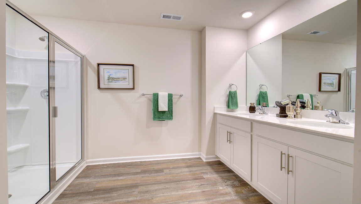 Primary bathroom with dual vanity and walk in shower