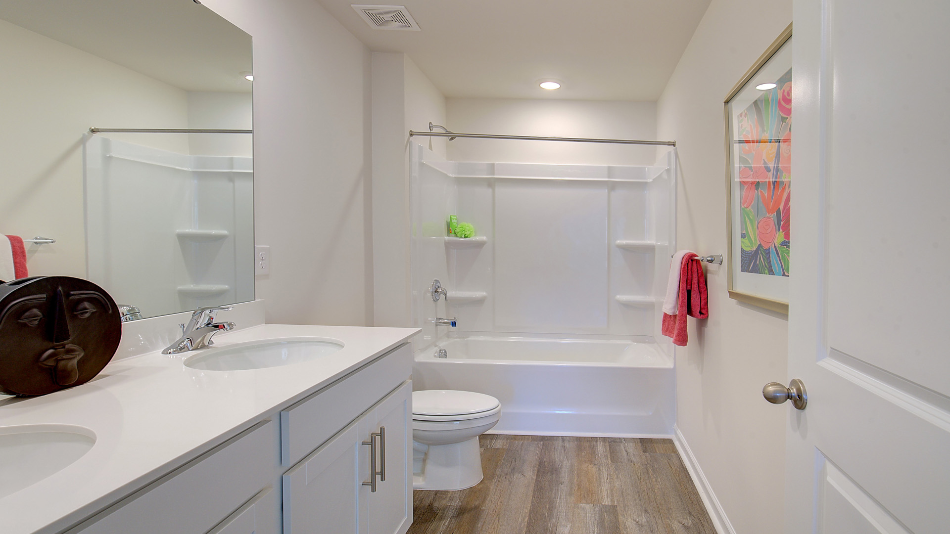 Bathroom with dual vanity and bathtub