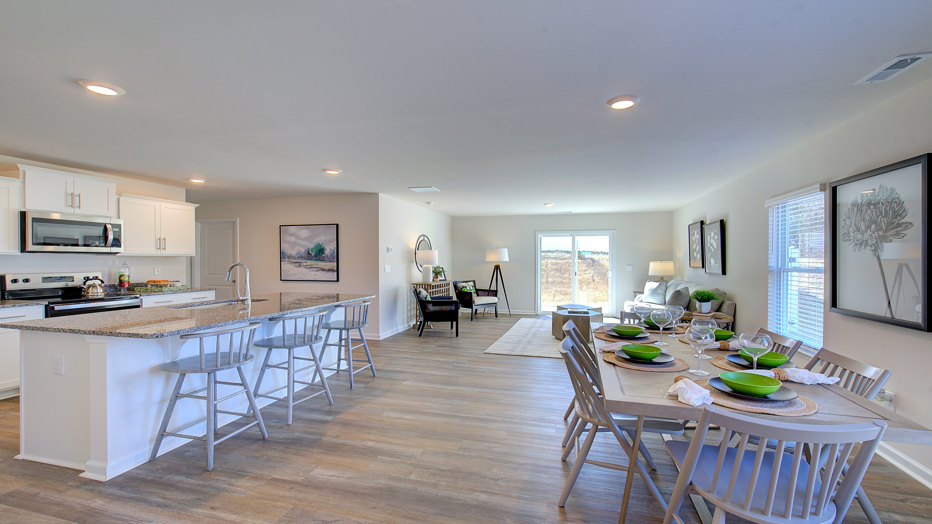 Open concept kitchen with stainless steel appliances and large island