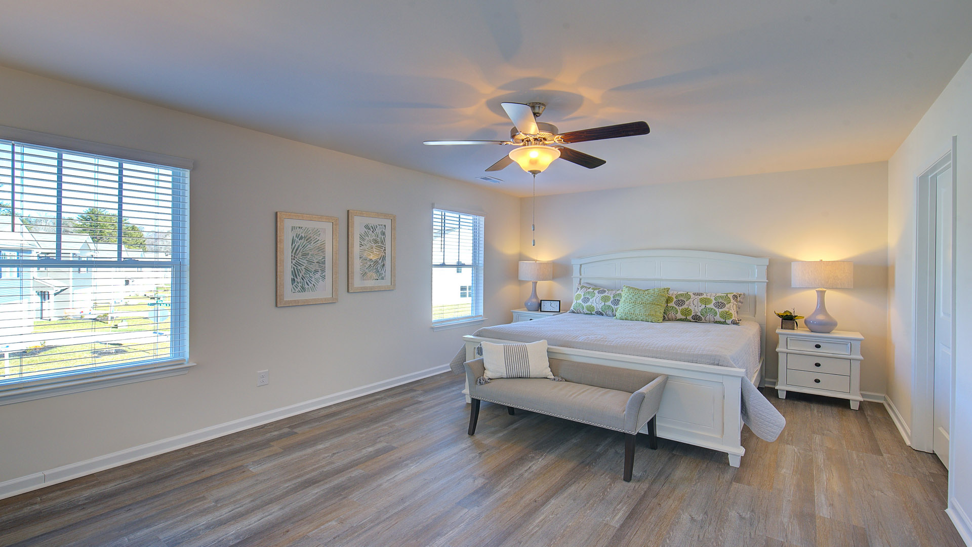Primary bedroom with large windows and attached bathroom