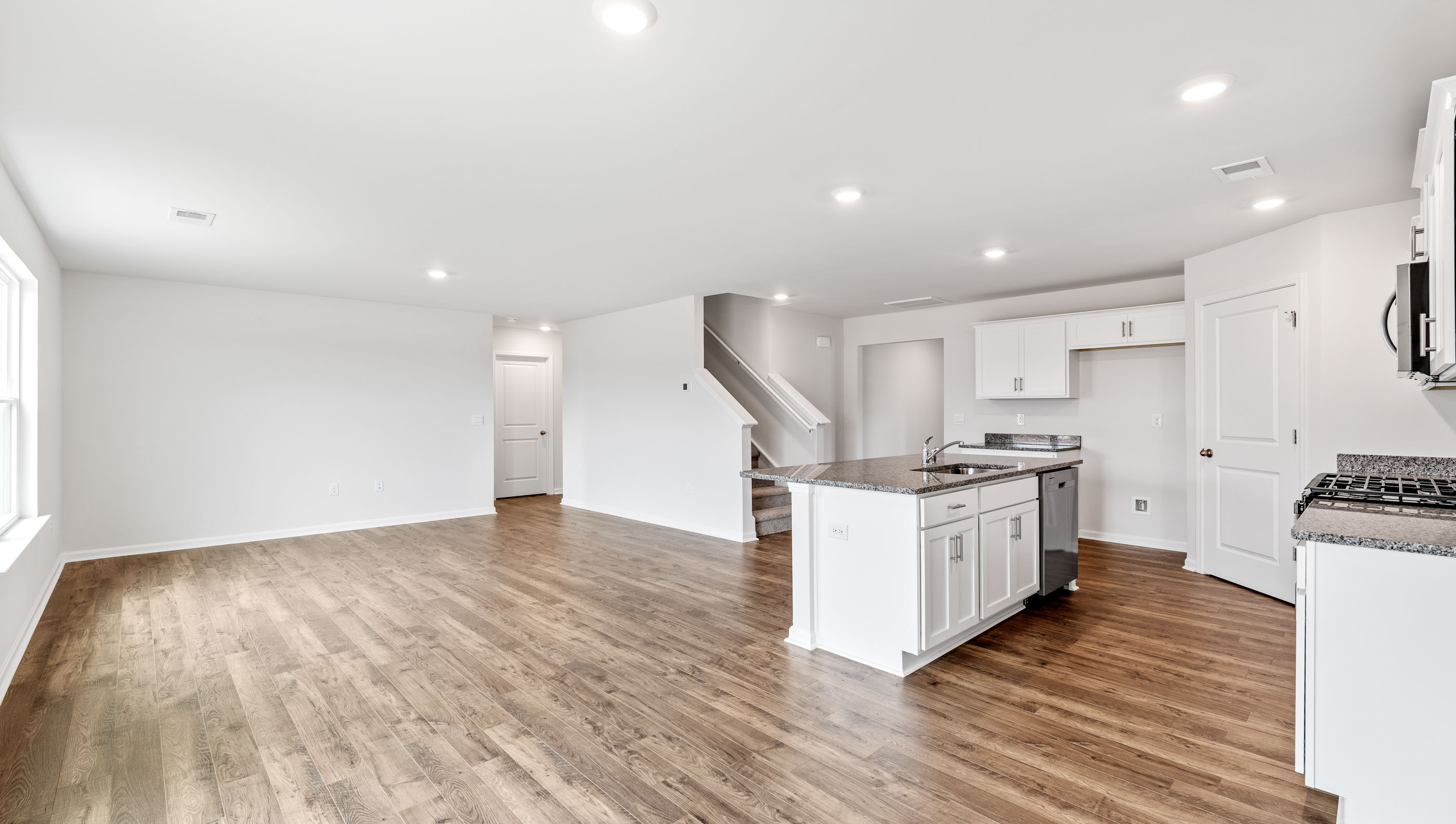 Open concept kitchen with large center island and stainless steel appliances
