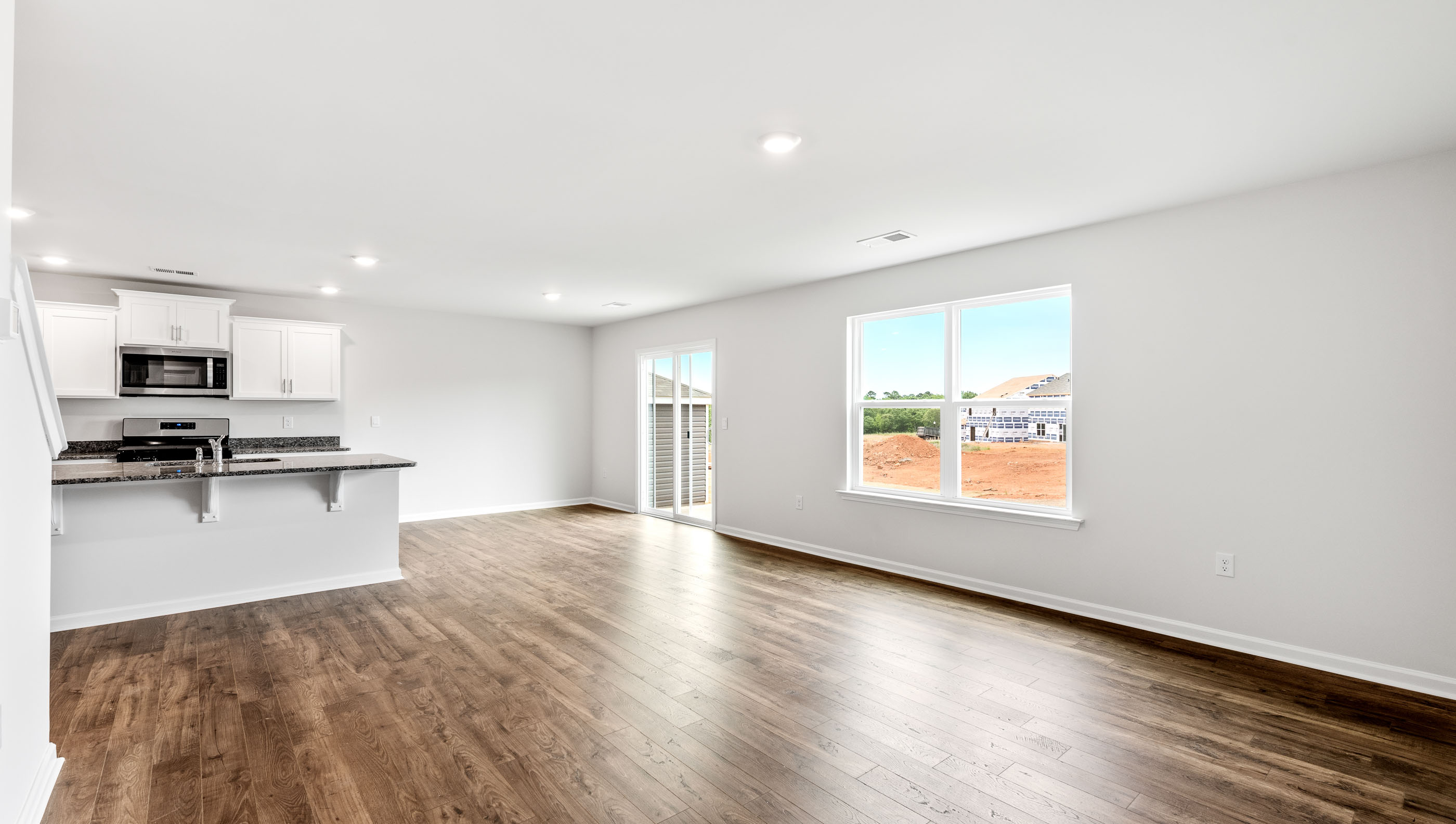 Open concept kitchen with large center island and stainless steel appliances