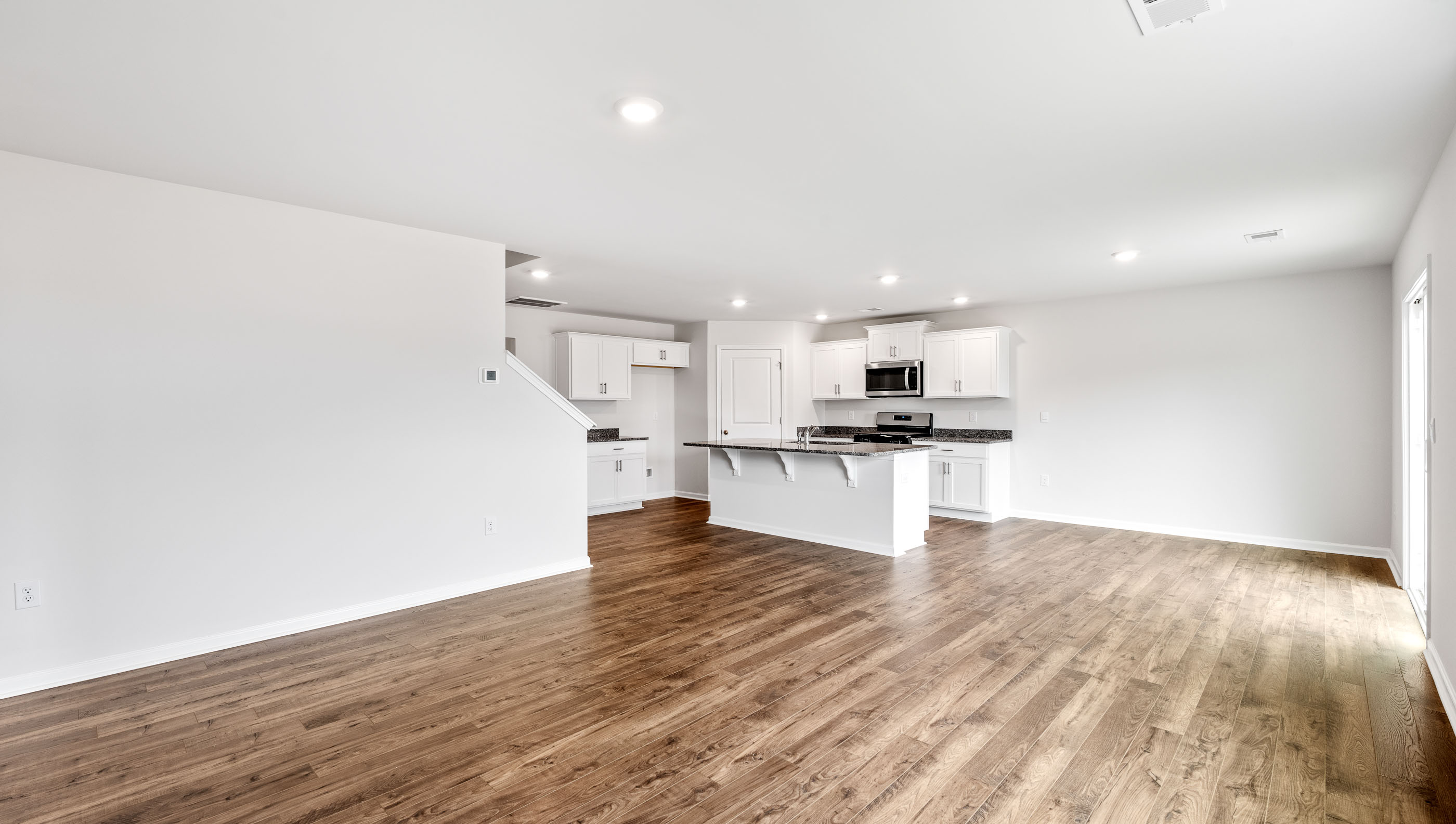 Open concept kitchen with large center island and stainless steel appliances