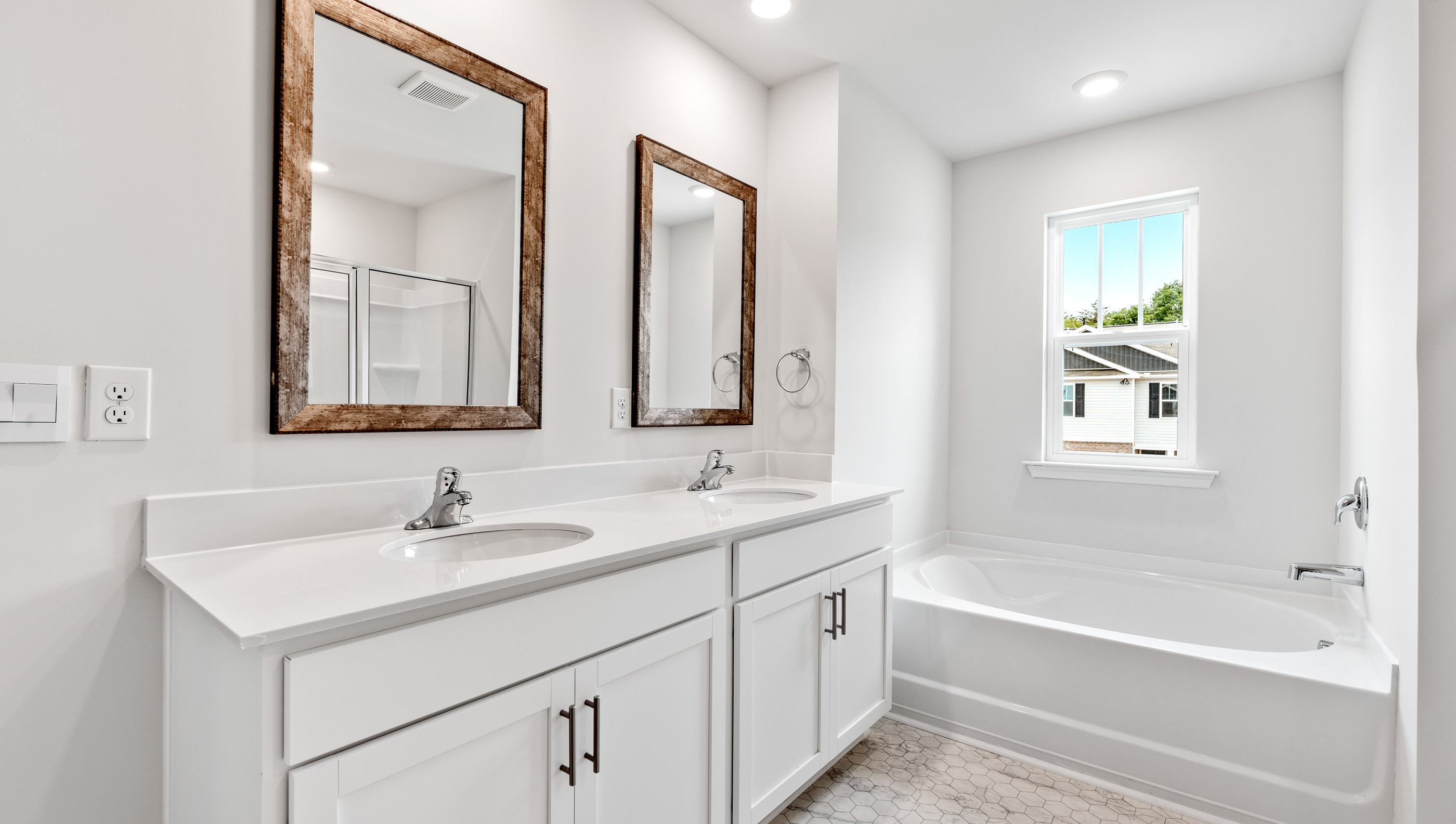 Bathroom with dual vanity and bathtub