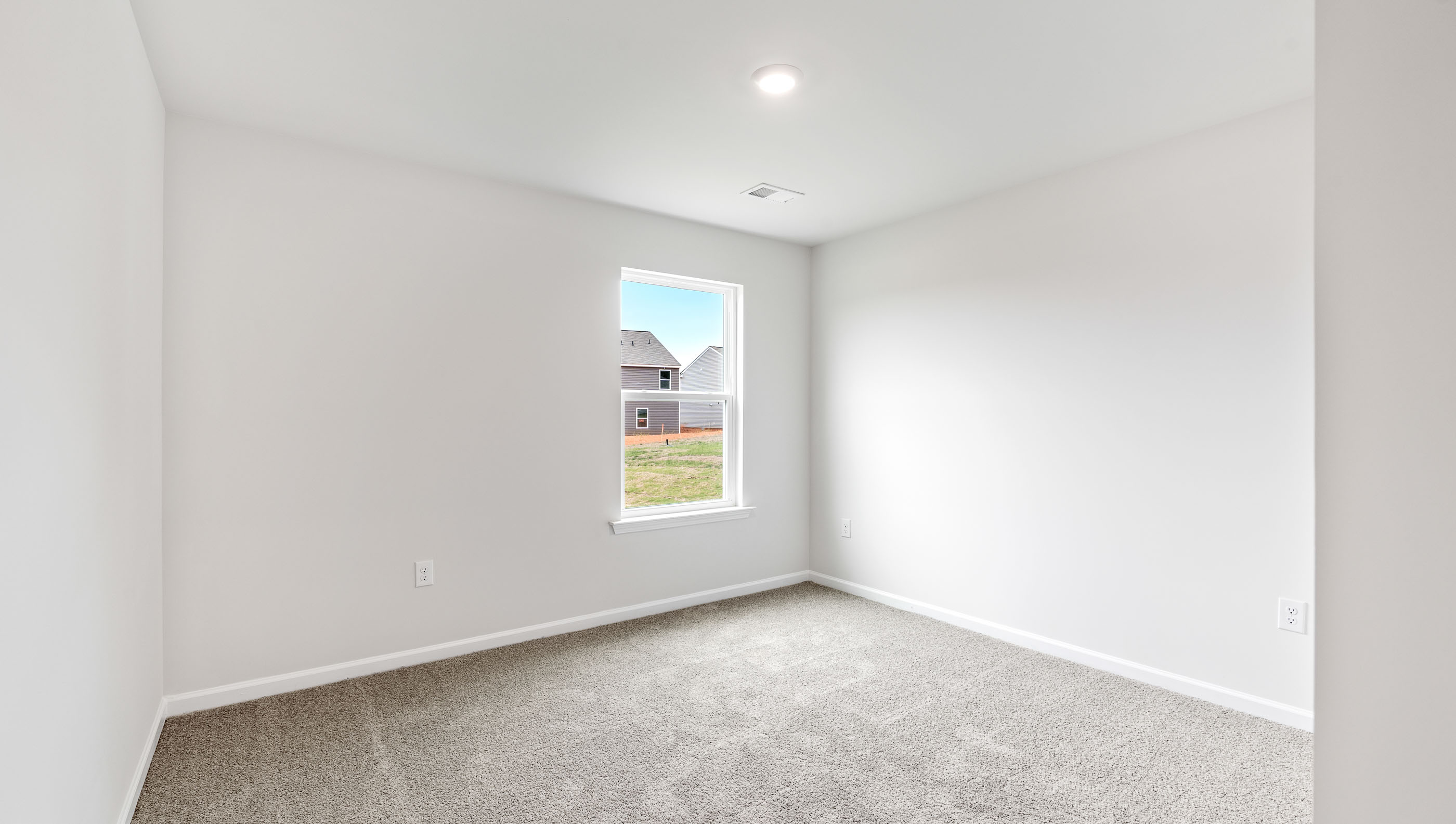 Carpeted bedroom with window