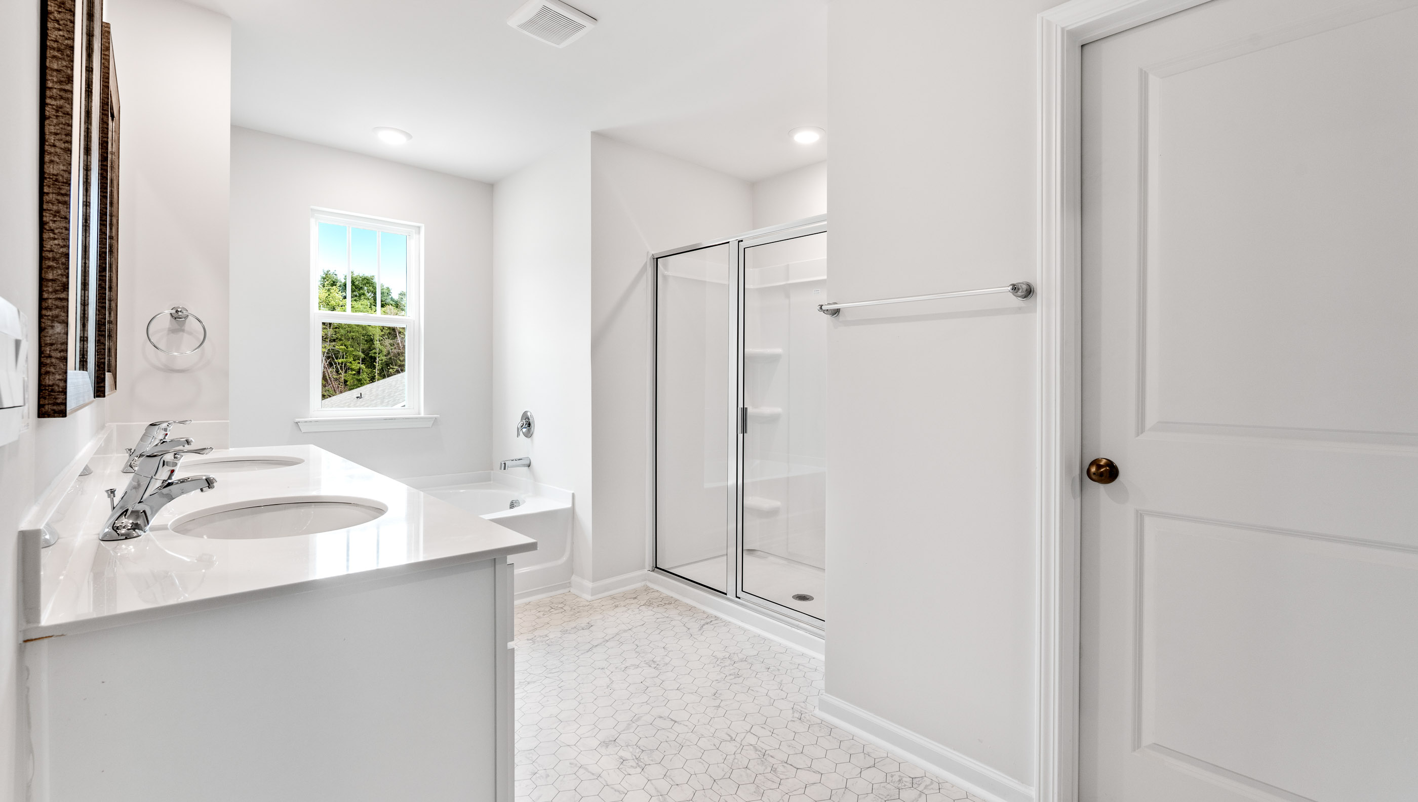 Primary bathroom with dual vanity and walk in shower
