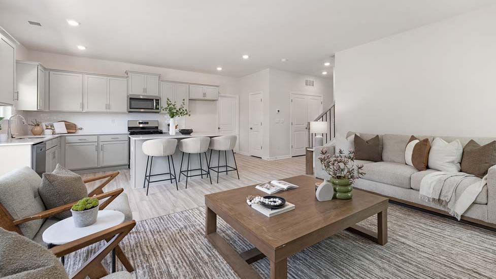 Open living room area with view of kitchen