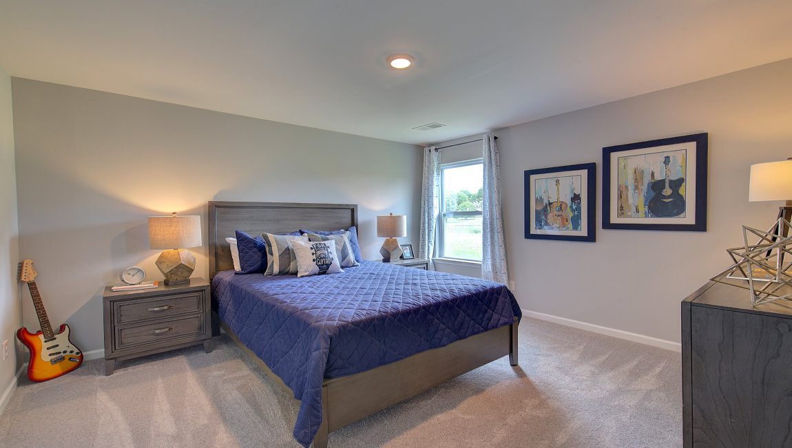 Carpeted bedroom with windows