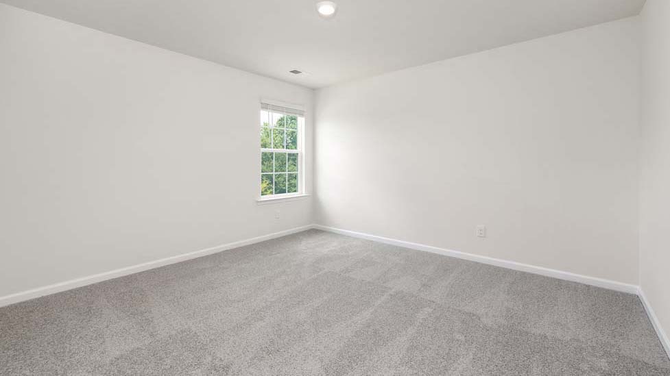 Carpeted bedroom with large windows