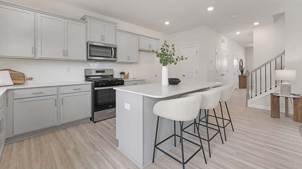 Open concept kitchen with large island and stainless steel appliances