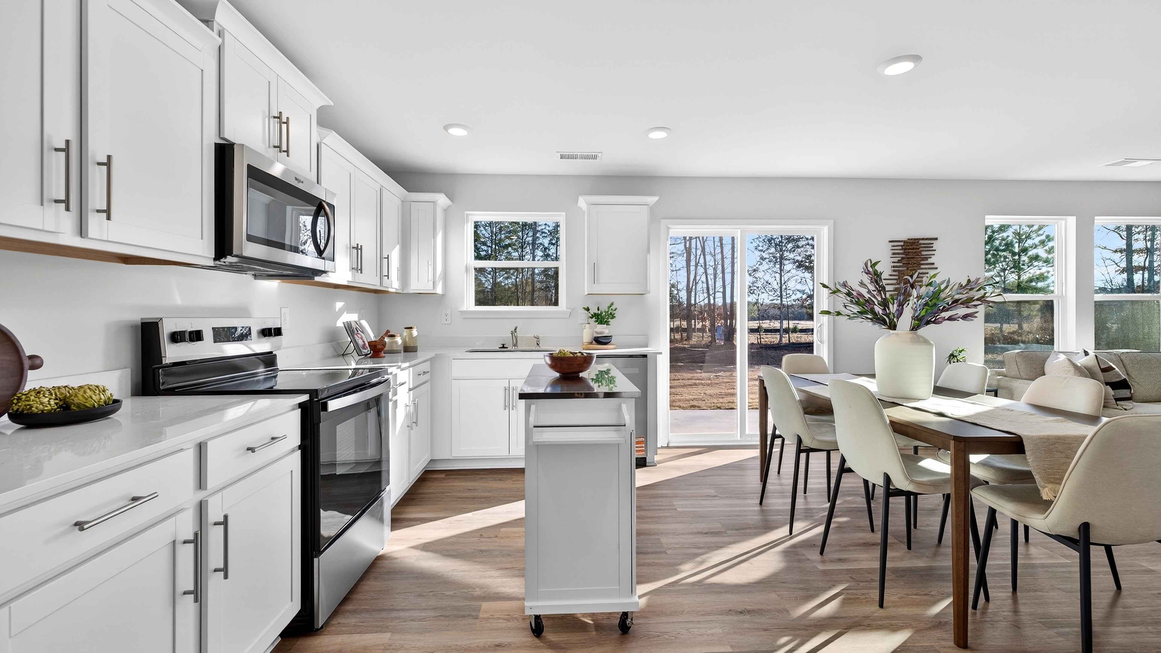 Open concept kitchen with stainless steel appliances and sliding glass doors