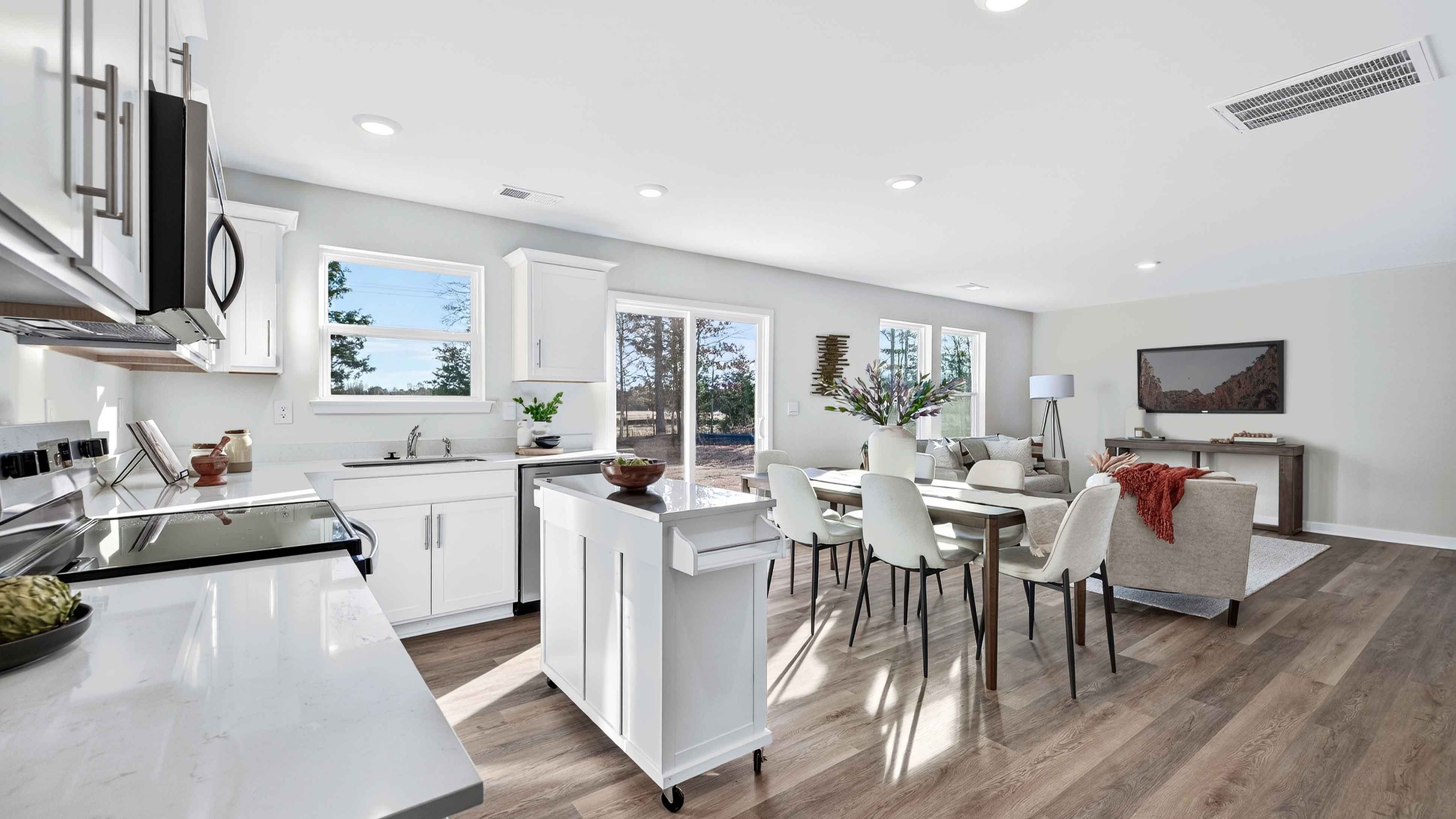 Open concept kitchen with stainless steel appliances and sliding glass doors