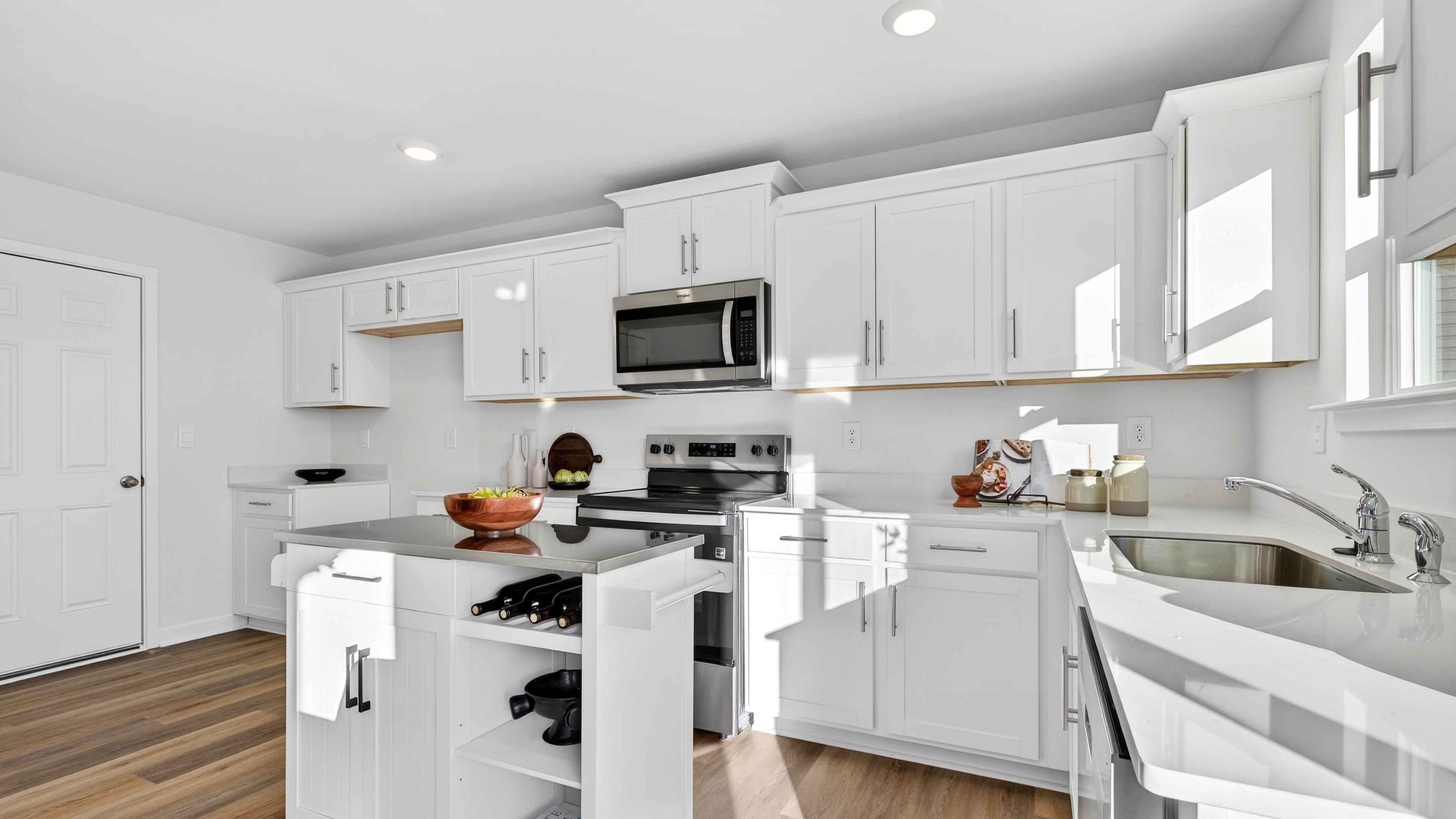 Open concept kitchen with stainless steel appliances and sliding glass doors
