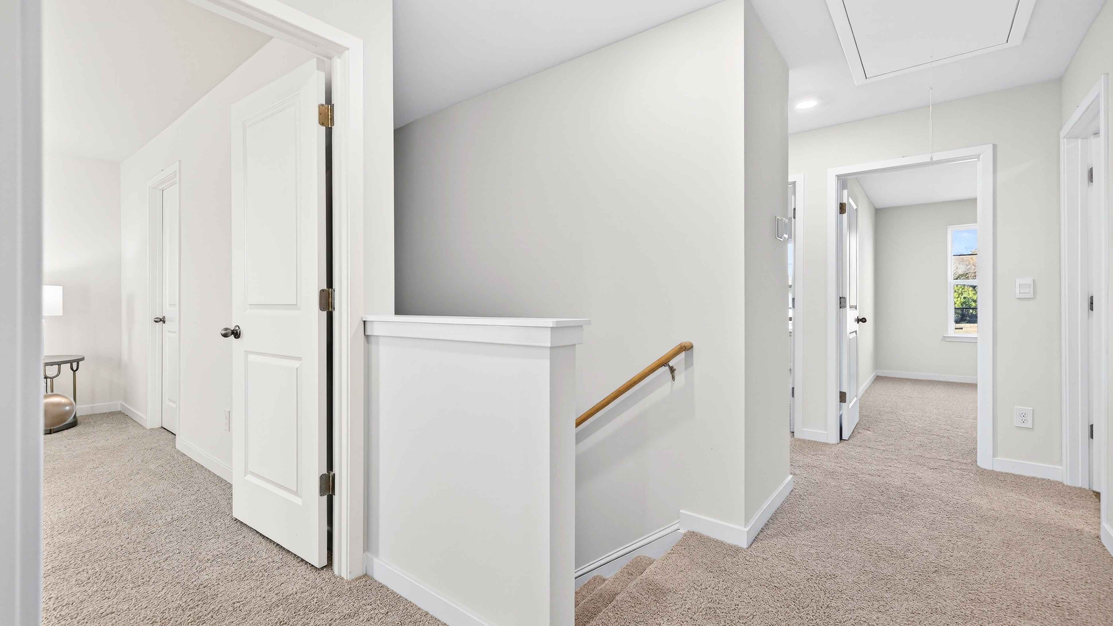 Carpeted upstairs landing area with stairs