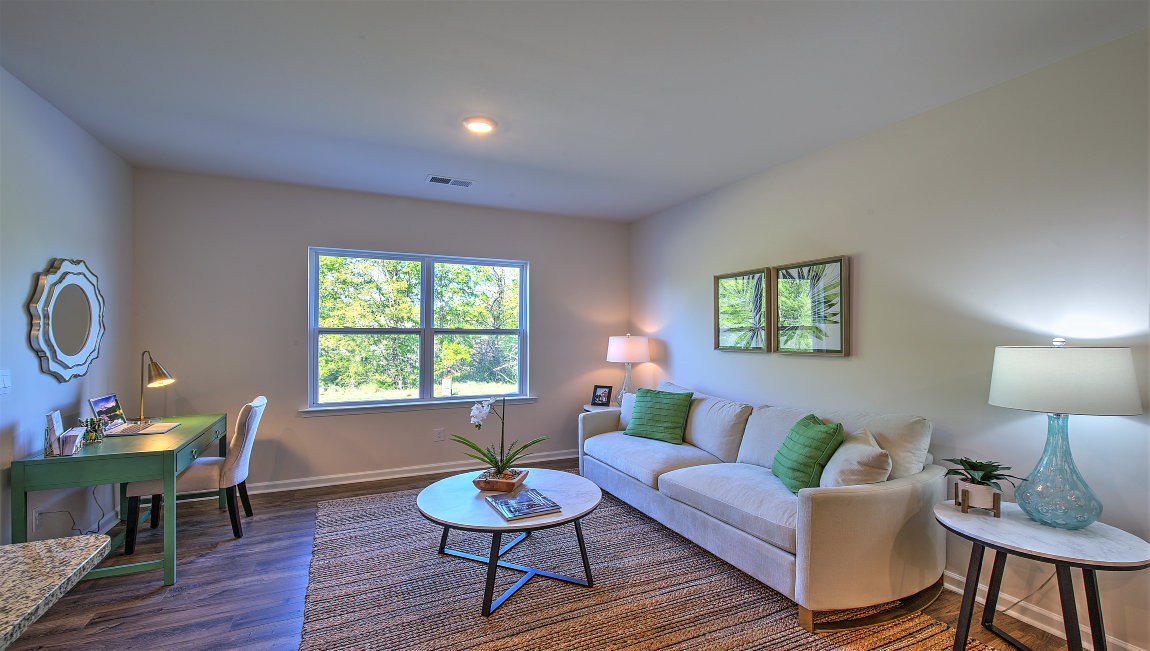 Family room with large window, beside kitchen