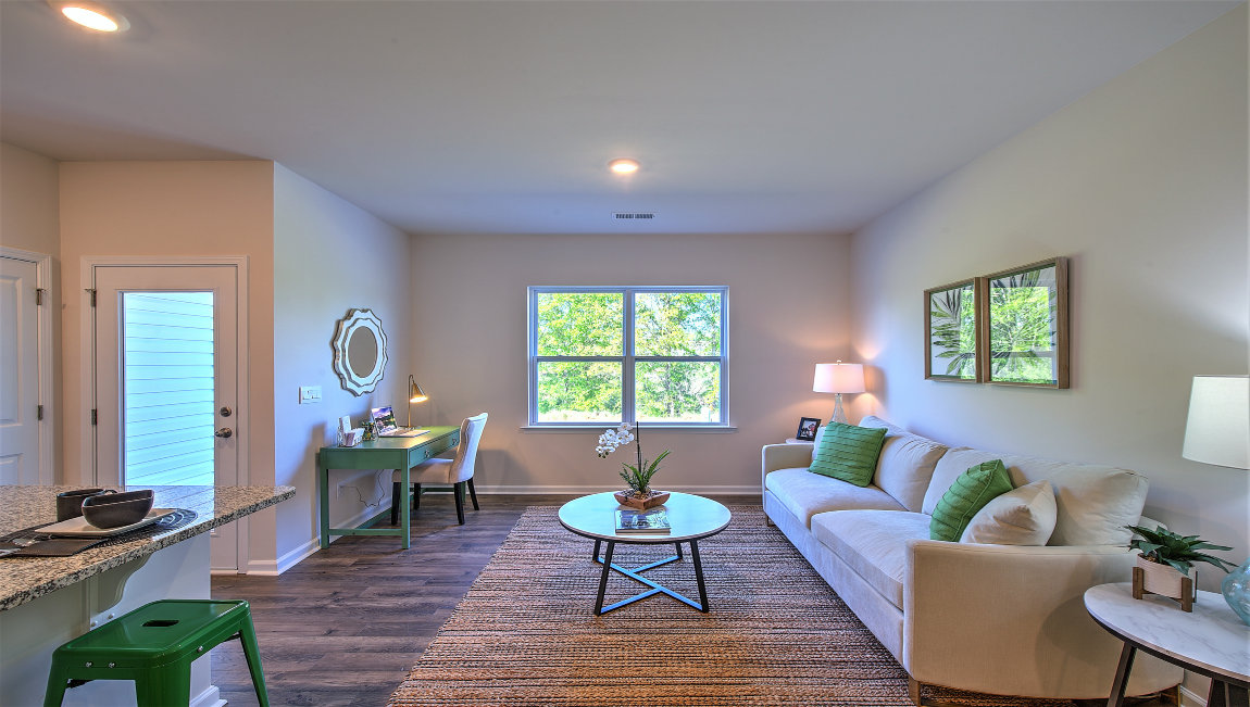Family room with large window, beside kitchen