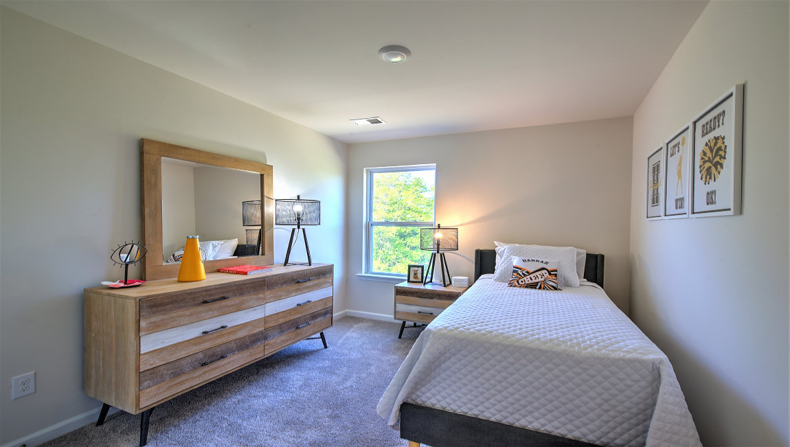 Carpeted bedroom with small window