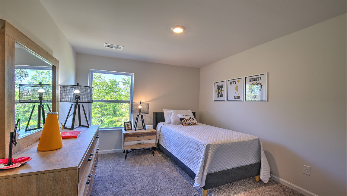 Carpeted bedroom with small window