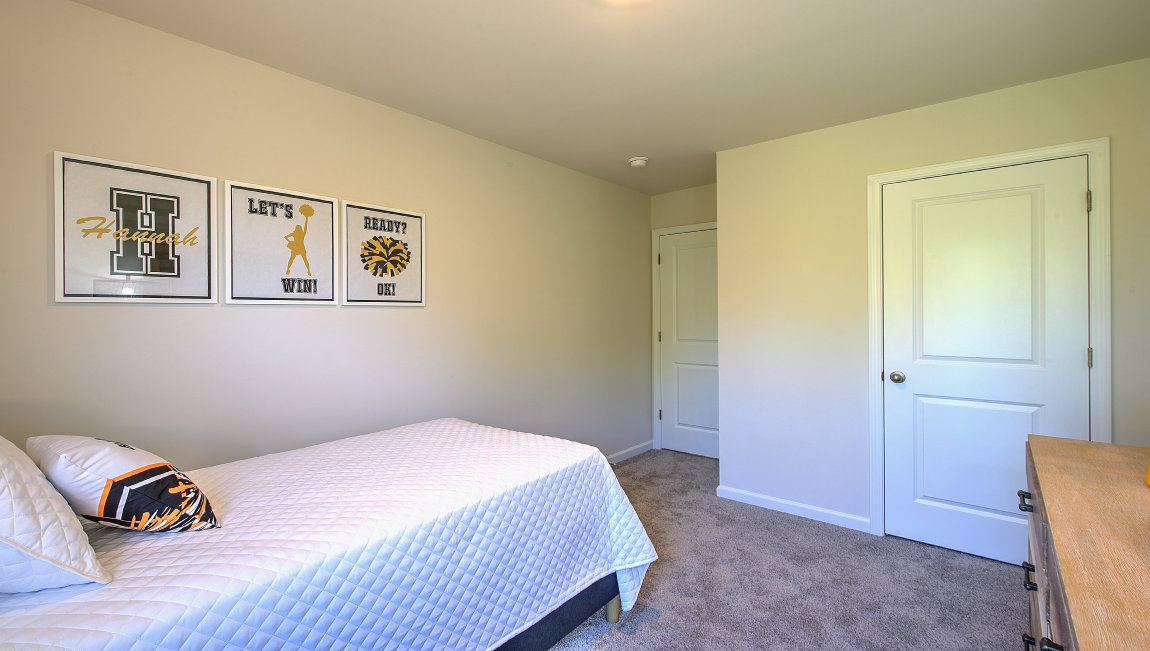 Carpeted bedroom with small window