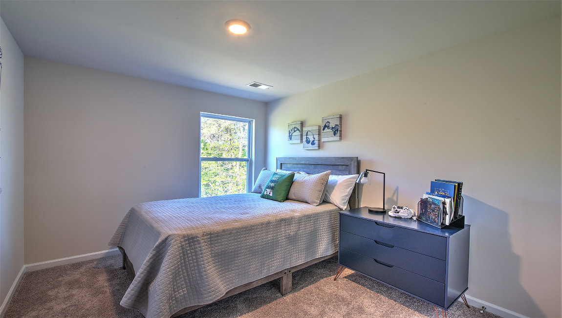 Carpeted bedroom with small window