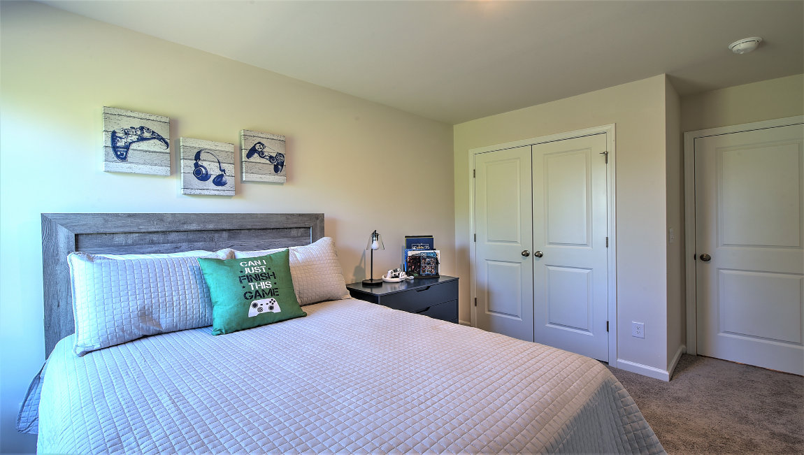 Carpeted bedroom with small window