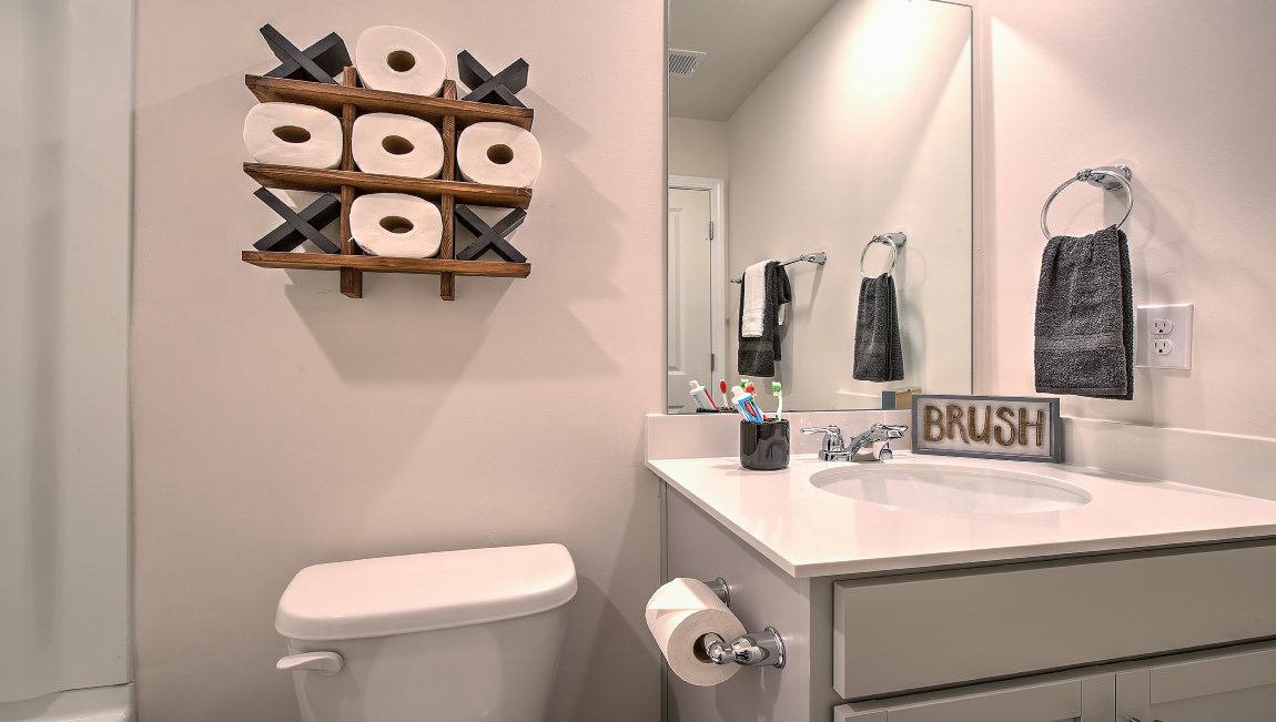 Bathroom with bathtub, white cabinets and counters