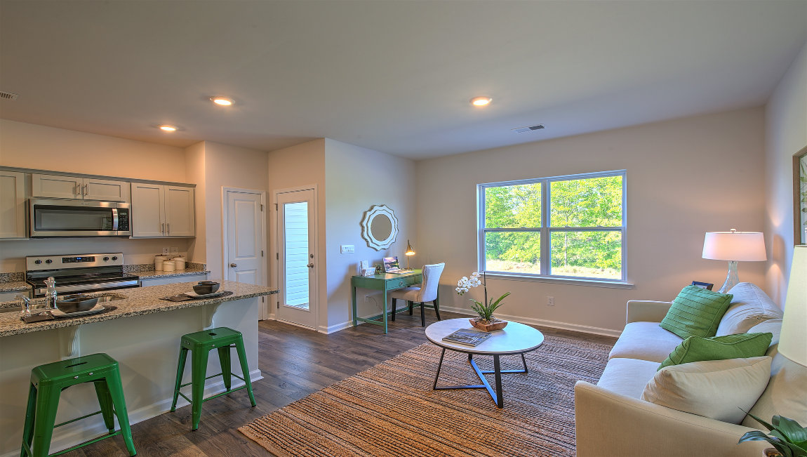 Family room with large window, beside kitchen