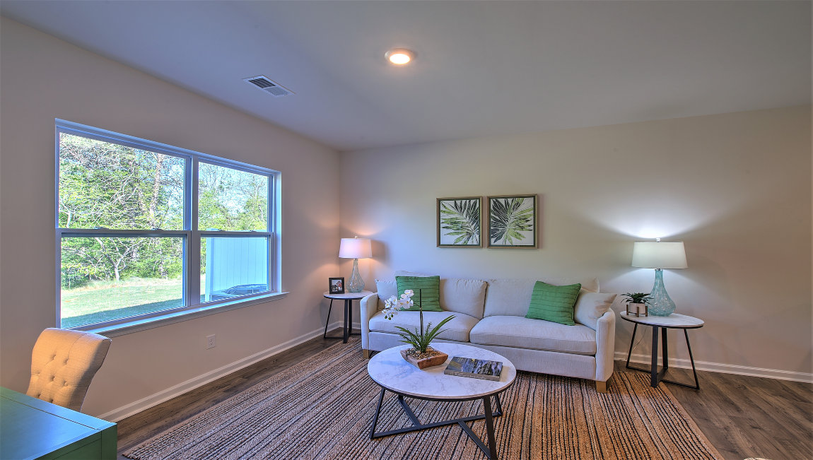 Family room with large window, beside kitchen