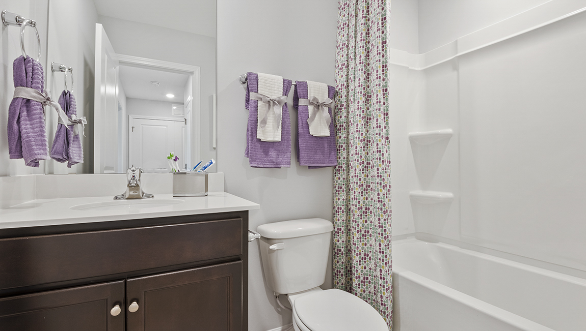 Bathroom with single vanity and bathtub