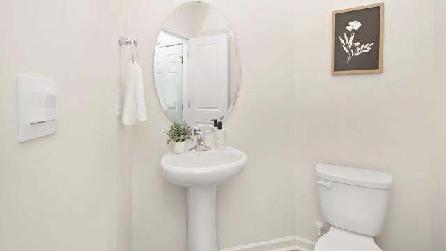 Half bathroom with single sink and mirror