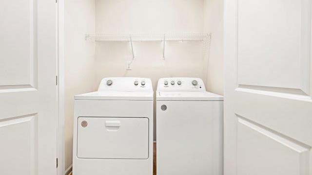 Laundry room with washer, dryer and shelving