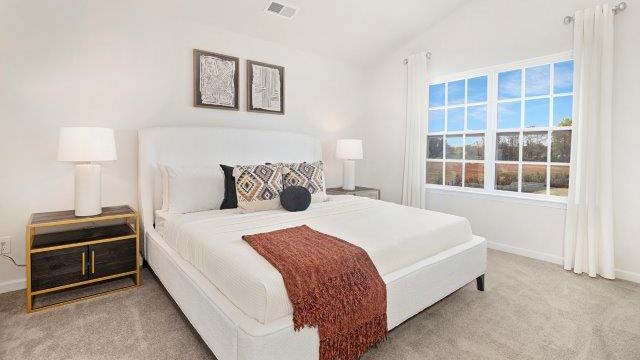 Primary bedroom with large windows