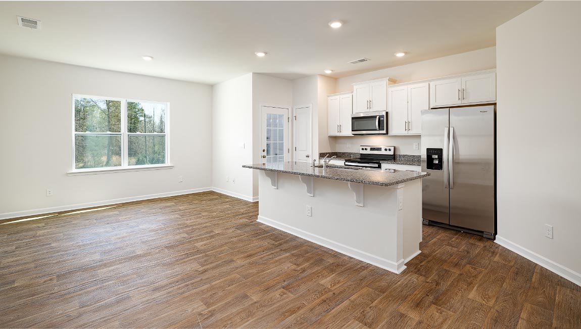 Open concept kitchen with stainless steel appliances and island