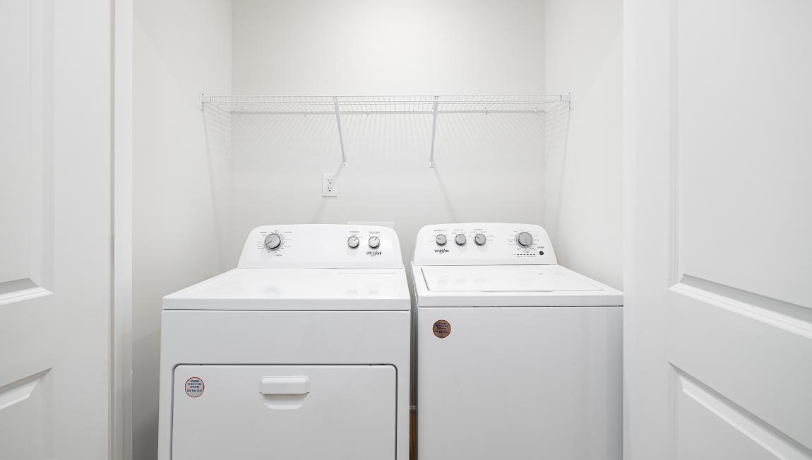 Laundry room with washer, dryer and shelving