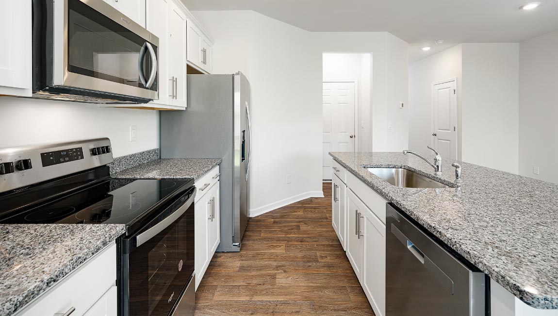 Open concept kitchen with stainless steel appliances and island