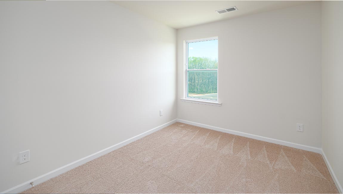 Carpeted bedroom with small window