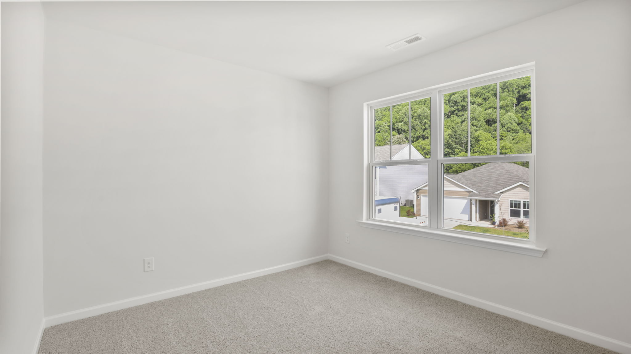 Carpeted bedroom with large windows