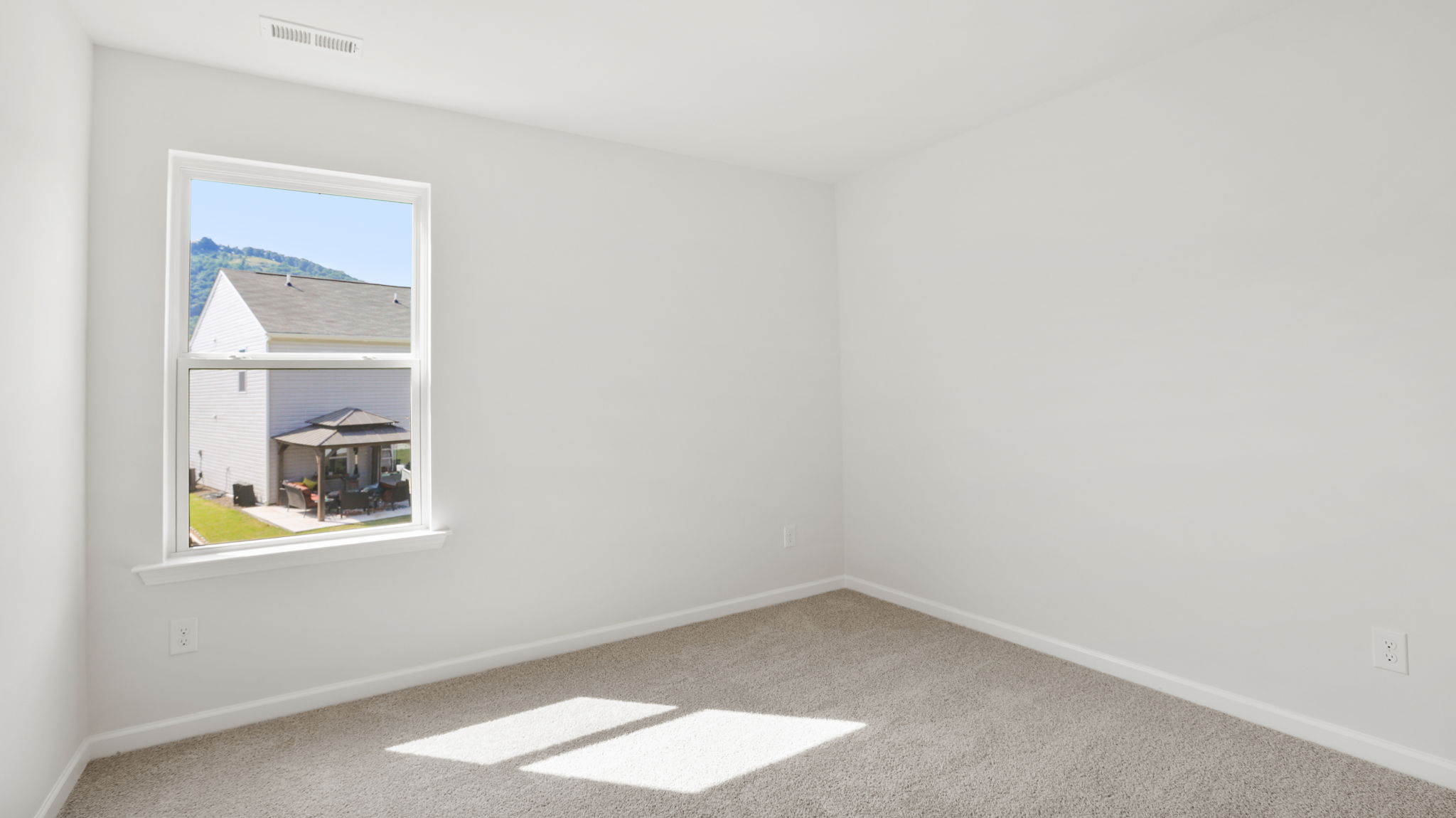 Carpeted bedroom with large windows