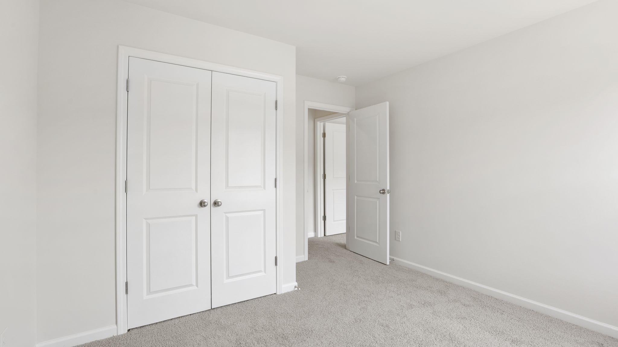 Carpeted bedroom with closet