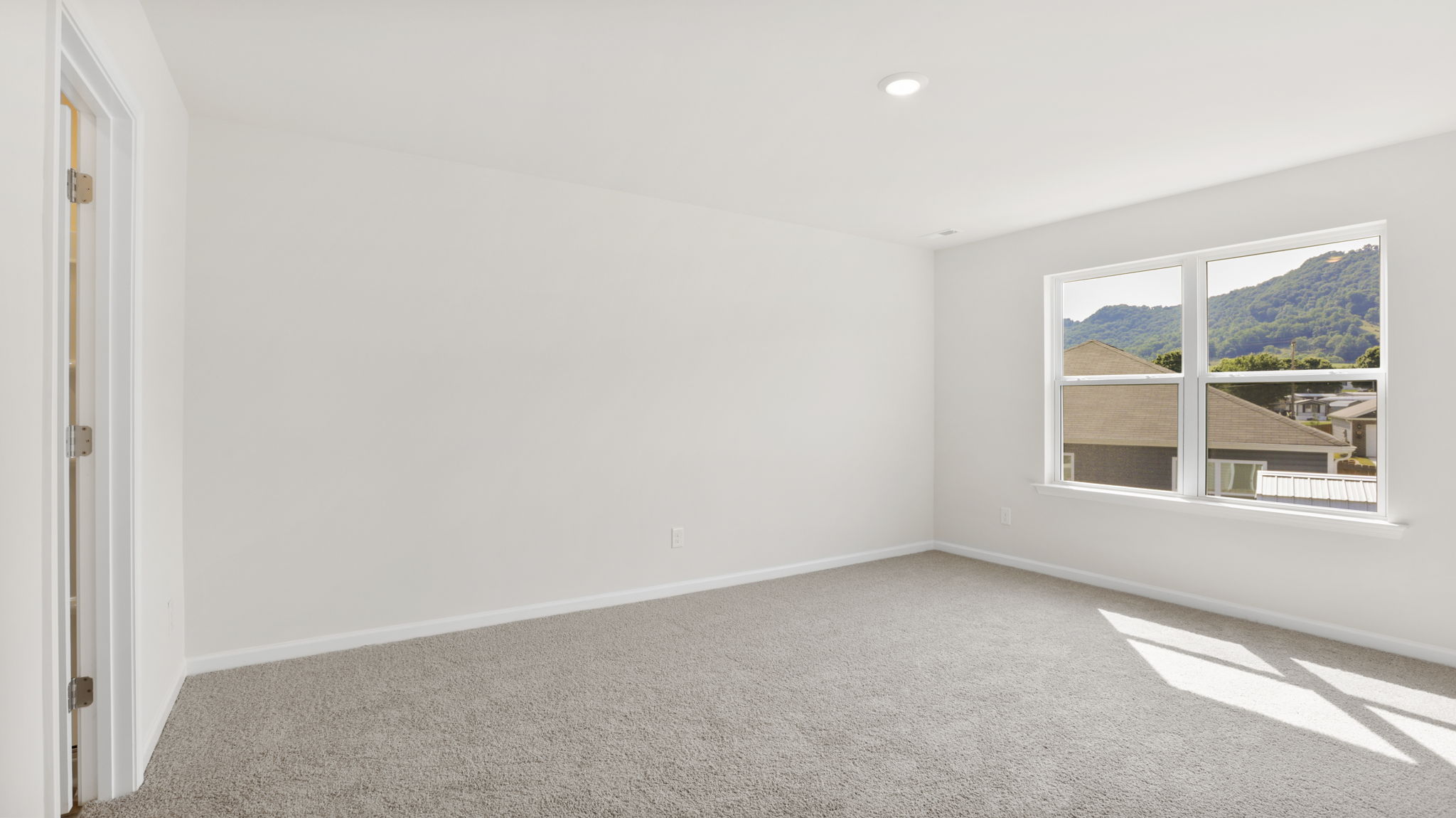 Carpeted bedroom with large windows